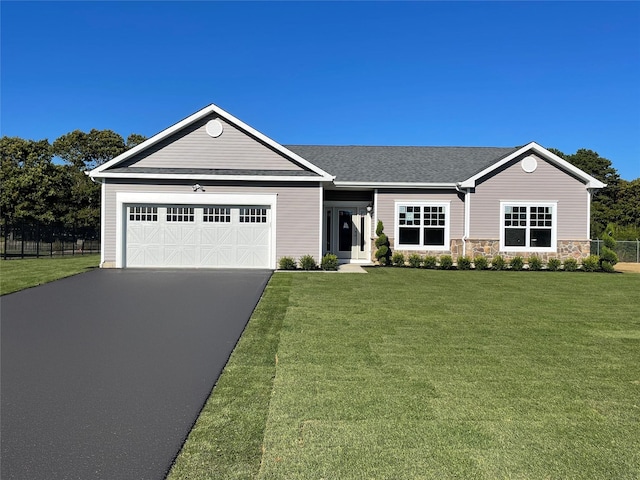 single story home with a garage and a front lawn