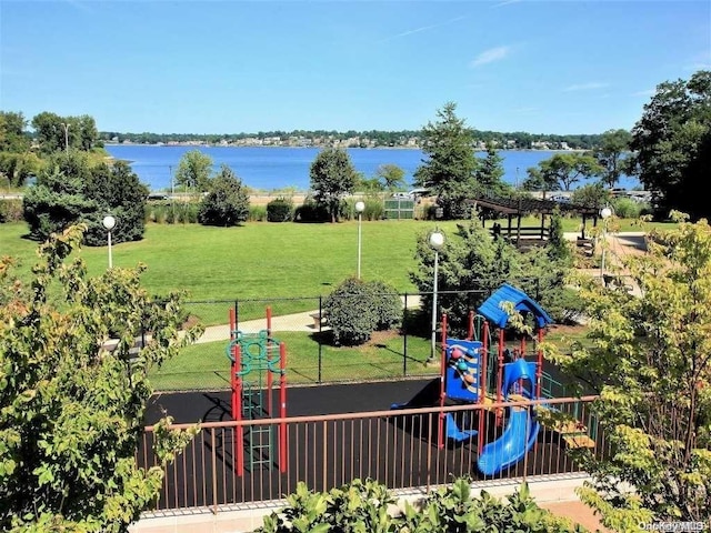 view of play area featuring a water view and a yard