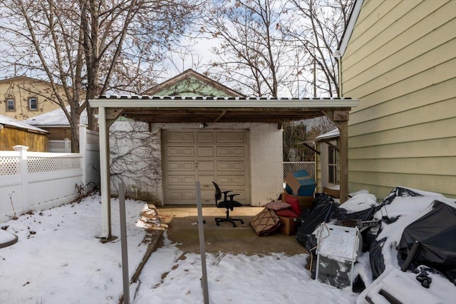 snow covered patio featuring a carport