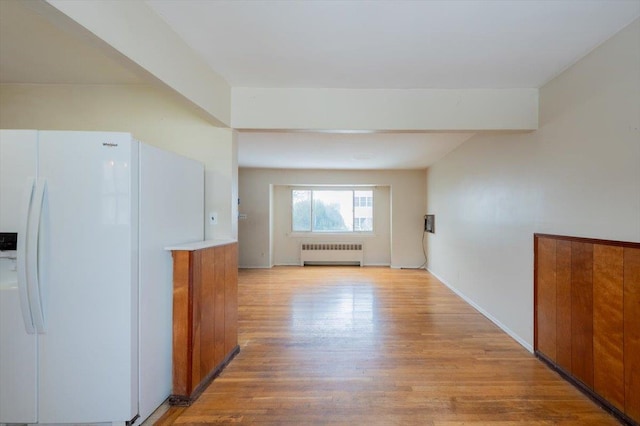 hallway with radiator heating unit and light hardwood / wood-style floors