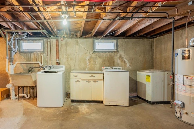 basement featuring water heater, fridge, sink, and washing machine and clothes dryer