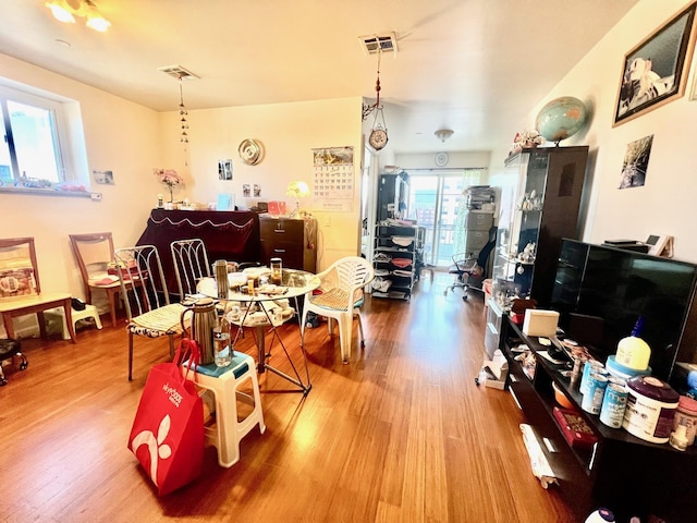 dining space with hardwood / wood-style floors