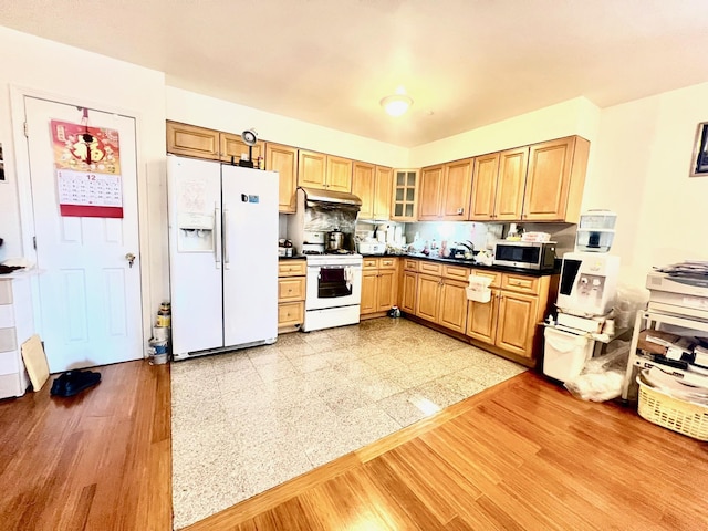 kitchen featuring white appliances and backsplash