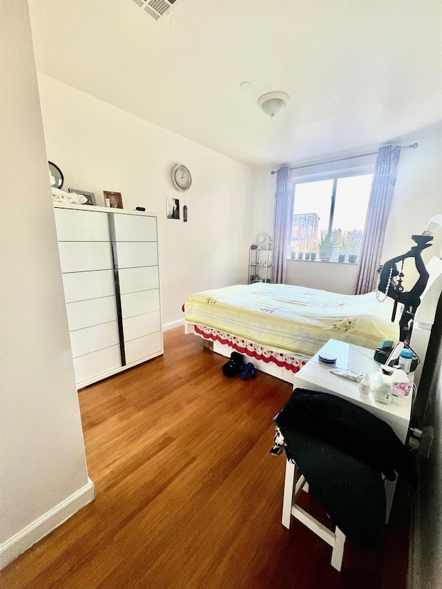 bedroom with wood-type flooring