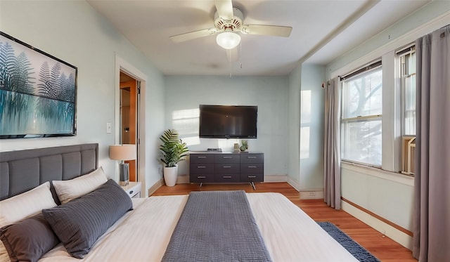 bedroom featuring ceiling fan, light wood-type flooring, and baseboards