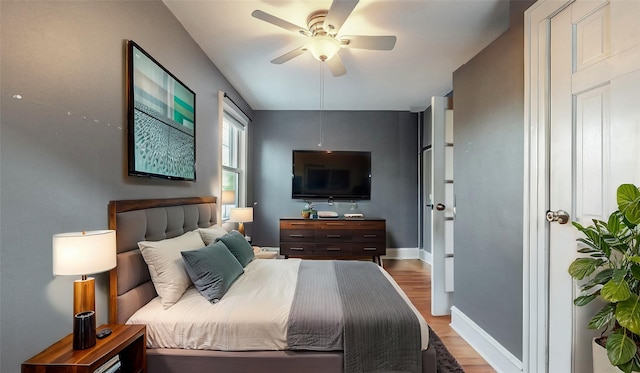 bedroom featuring light wood-type flooring, ceiling fan, and baseboards