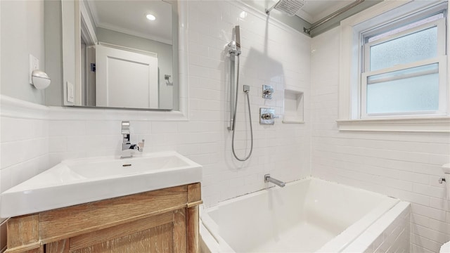 full bath featuring shower / bathing tub combination, vanity, tile walls, and crown molding