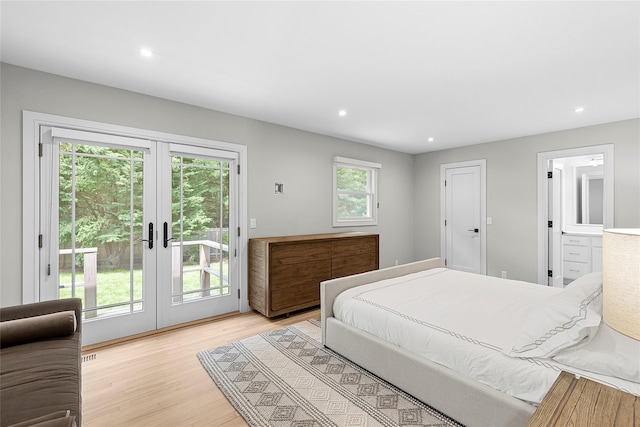 bedroom featuring connected bathroom, access to outside, light wood-type flooring, and french doors