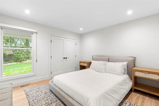 bedroom featuring light wood-type flooring and a closet