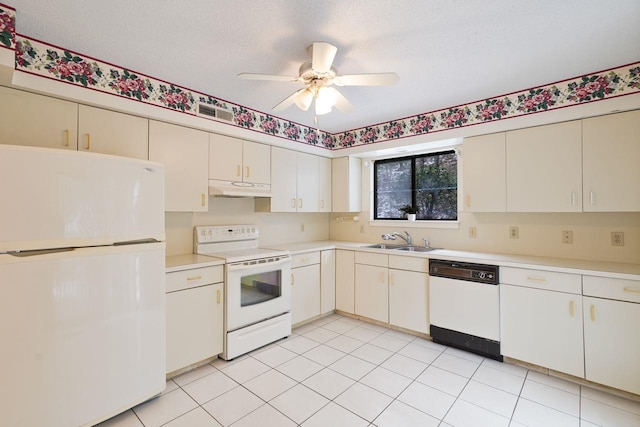 kitchen featuring sink, white appliances, light tile patterned floors, ceiling fan, and a textured ceiling