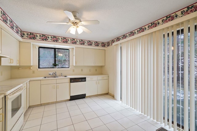 kitchen featuring sink, white appliances, a textured ceiling, light tile patterned floors, and ceiling fan