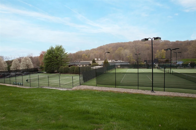 view of sport court featuring a lawn