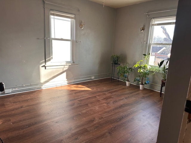 unfurnished room with dark wood finished floors