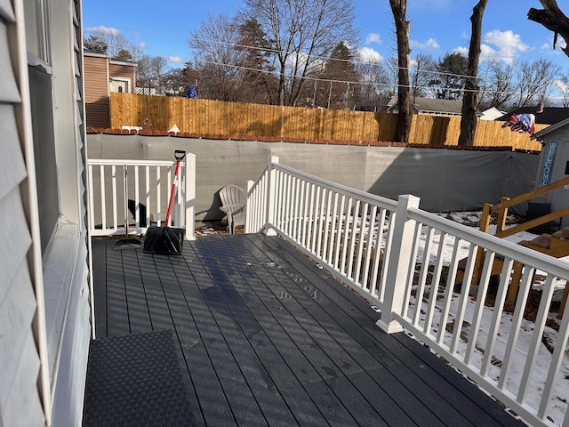 wooden terrace with a fenced backyard