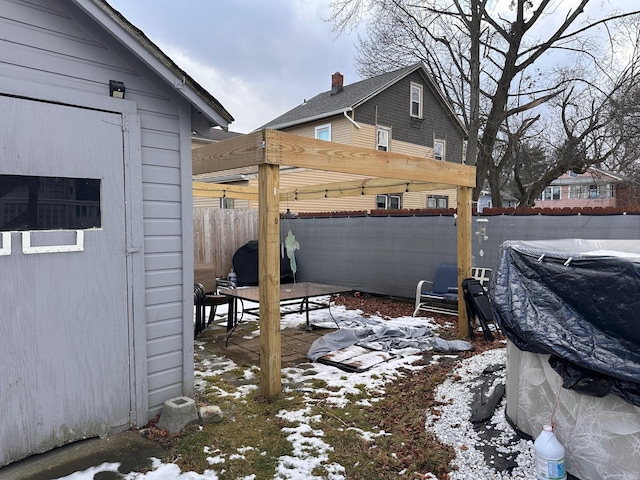 yard covered in snow featuring fence