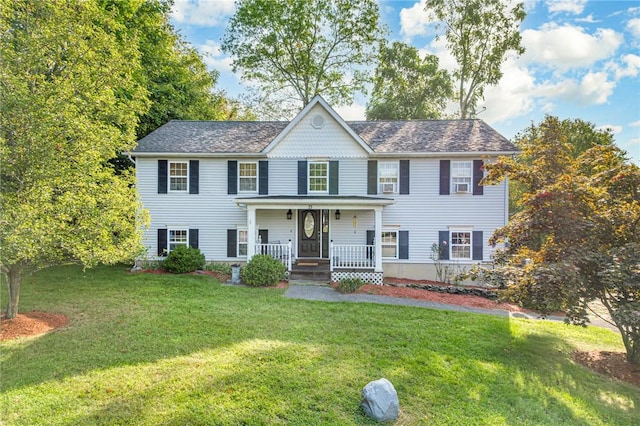 colonial home with a front yard and covered porch