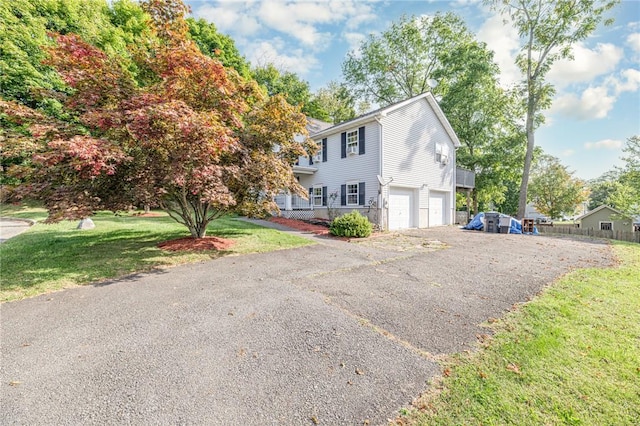 view of front of house with a garage and a front lawn