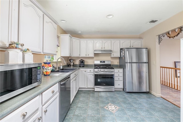 kitchen with white cabinetry, stainless steel appliances, sink, and light tile patterned floors