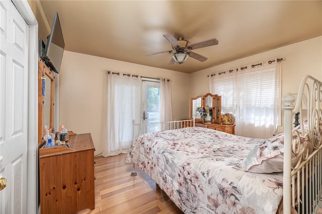 bedroom with light hardwood / wood-style flooring and ceiling fan