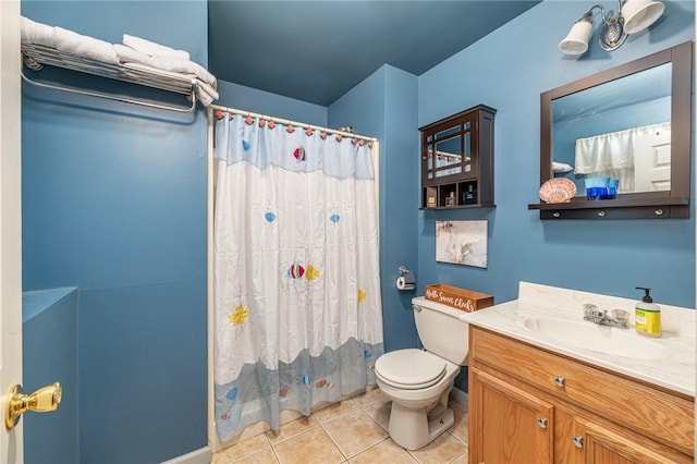 bathroom featuring vanity, tile patterned floors, and toilet