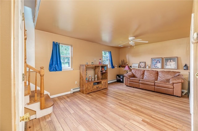 living room featuring a baseboard radiator, hardwood / wood-style floors, and ceiling fan