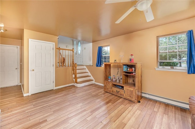 interior space featuring a baseboard radiator, plenty of natural light, and light hardwood / wood-style flooring