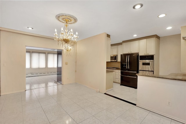 kitchen featuring a baseboard heating unit, baseboards, appliances with stainless steel finishes, and recessed lighting