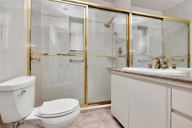 full bath with tile patterned flooring, toilet, vanity, tile walls, and a stall shower