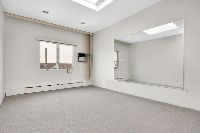 carpeted spare room featuring a baseboard heating unit, a baseboard radiator, and a skylight