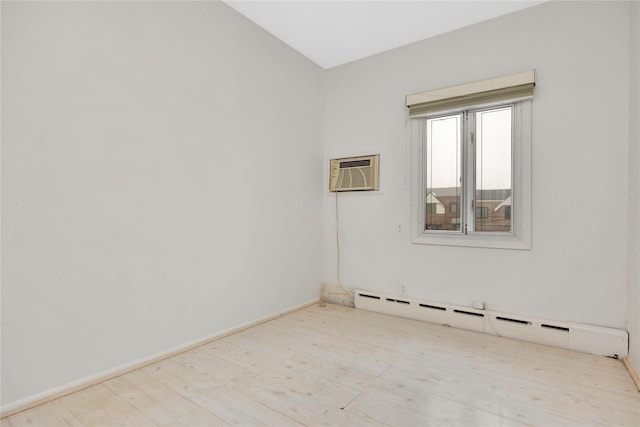 spare room with baseboards, a wall mounted air conditioner, baseboard heating, and wood finished floors