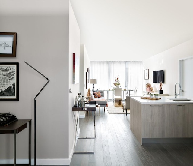 kitchen with sink, dark hardwood / wood-style floors, and kitchen peninsula