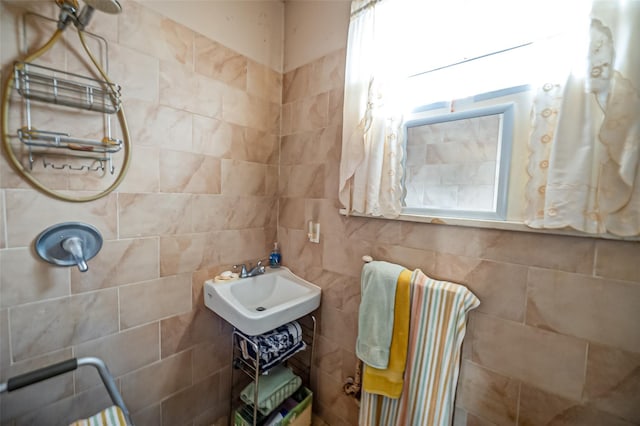 bathroom with sink and tile walls