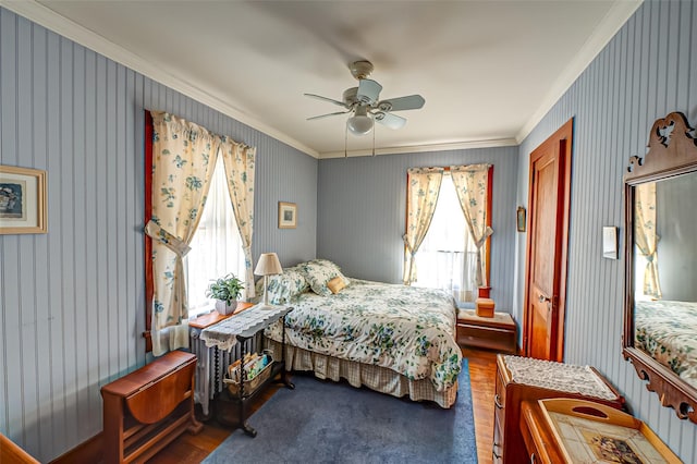 bedroom with ceiling fan, ornamental molding, and dark hardwood / wood-style flooring