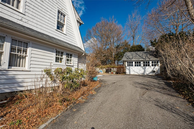 view of home's exterior featuring an outbuilding