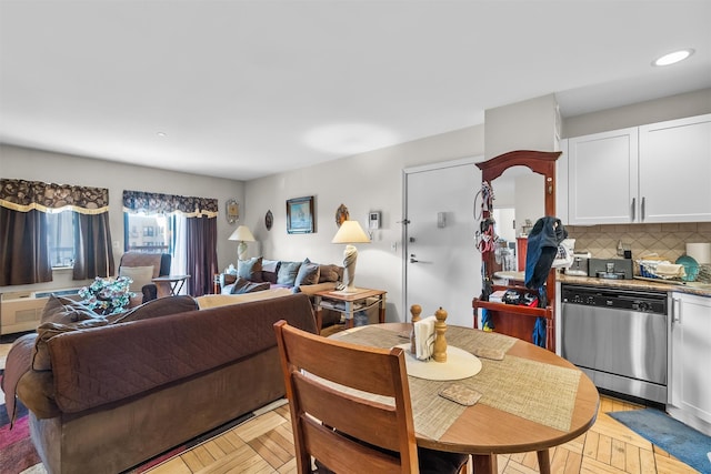 dining room featuring light parquet floors and a wall mounted AC