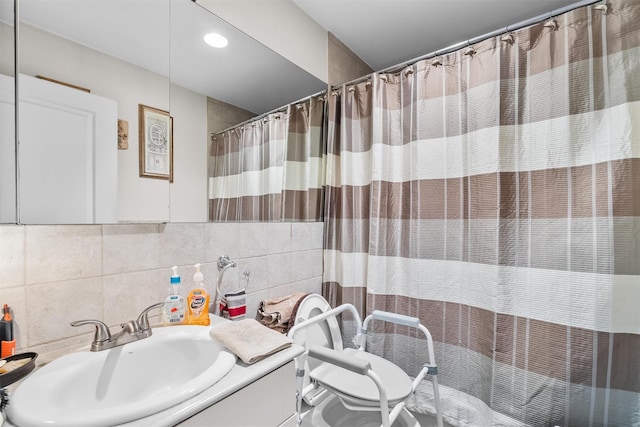 bathroom with tile walls, backsplash, vanity, a shower with curtain, and toilet