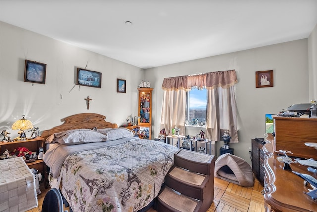 bedroom with light parquet flooring