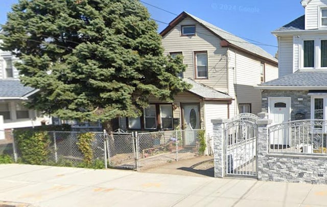 view of front facade with a fenced front yard and a gate