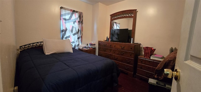 bedroom with dark wood-type flooring