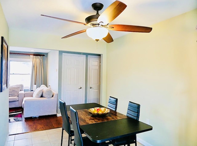 tiled dining area featuring ceiling fan