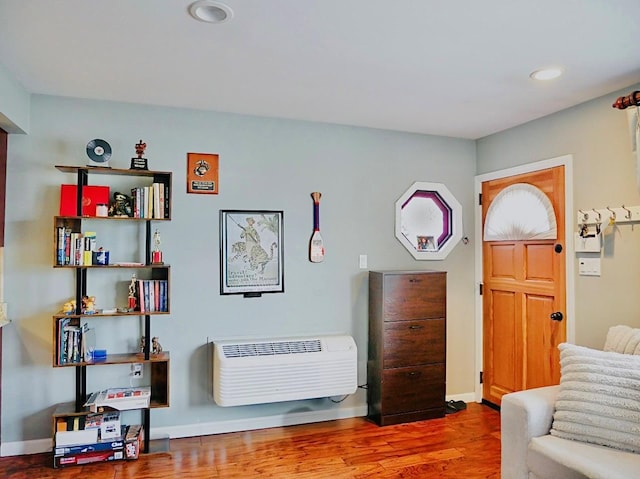 sitting room with hardwood / wood-style flooring