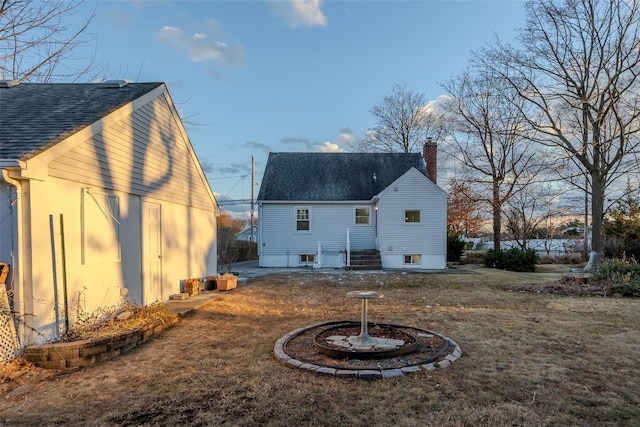 back of house with a lawn