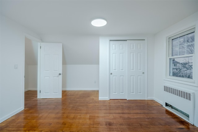 unfurnished room with radiator and dark hardwood / wood-style flooring