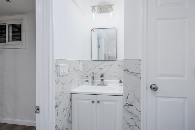 bathroom featuring vanity and tile walls