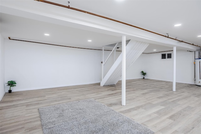 basement featuring gas water heater and light wood-type flooring