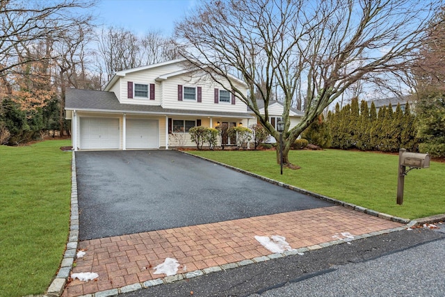 view of property featuring a garage and a front lawn