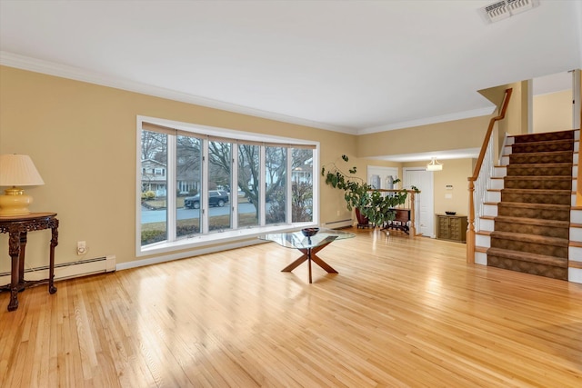 living room featuring ornamental molding, light hardwood / wood-style floors, and a baseboard heating unit