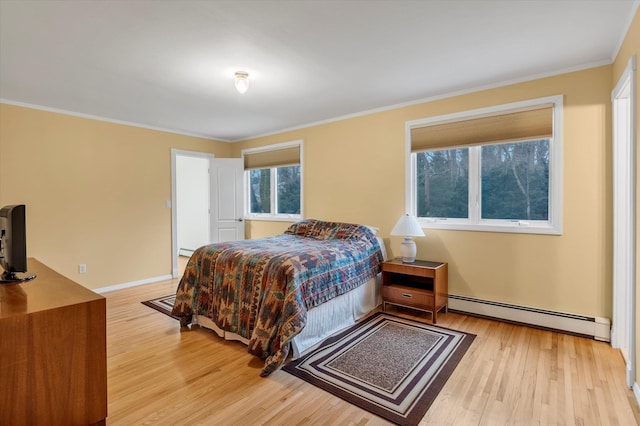 bedroom featuring light hardwood / wood-style flooring, crown molding, and a baseboard radiator