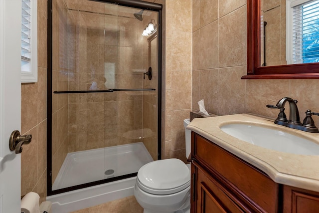 bathroom featuring a healthy amount of sunlight, tile walls, an enclosed shower, and toilet