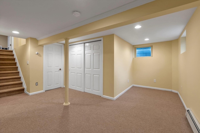 basement with carpet floors and a baseboard heating unit